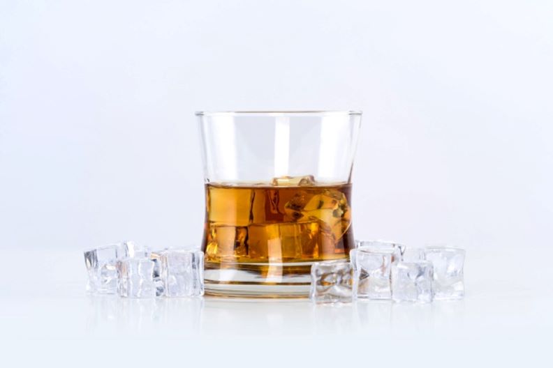 glass whiskey with ice cubes